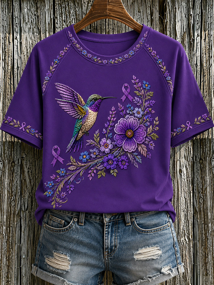 Damen-T-Shirt in Lila mit Blumen- und Kolibri-Print zur Sensibilisierung für die Alzheimer-Krankheit