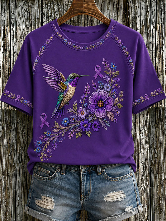 Damen-T-Shirt in Lila mit Blumen- und Kolibri-Print zur Sensibilisierung für die Alzheimer-Krankheit