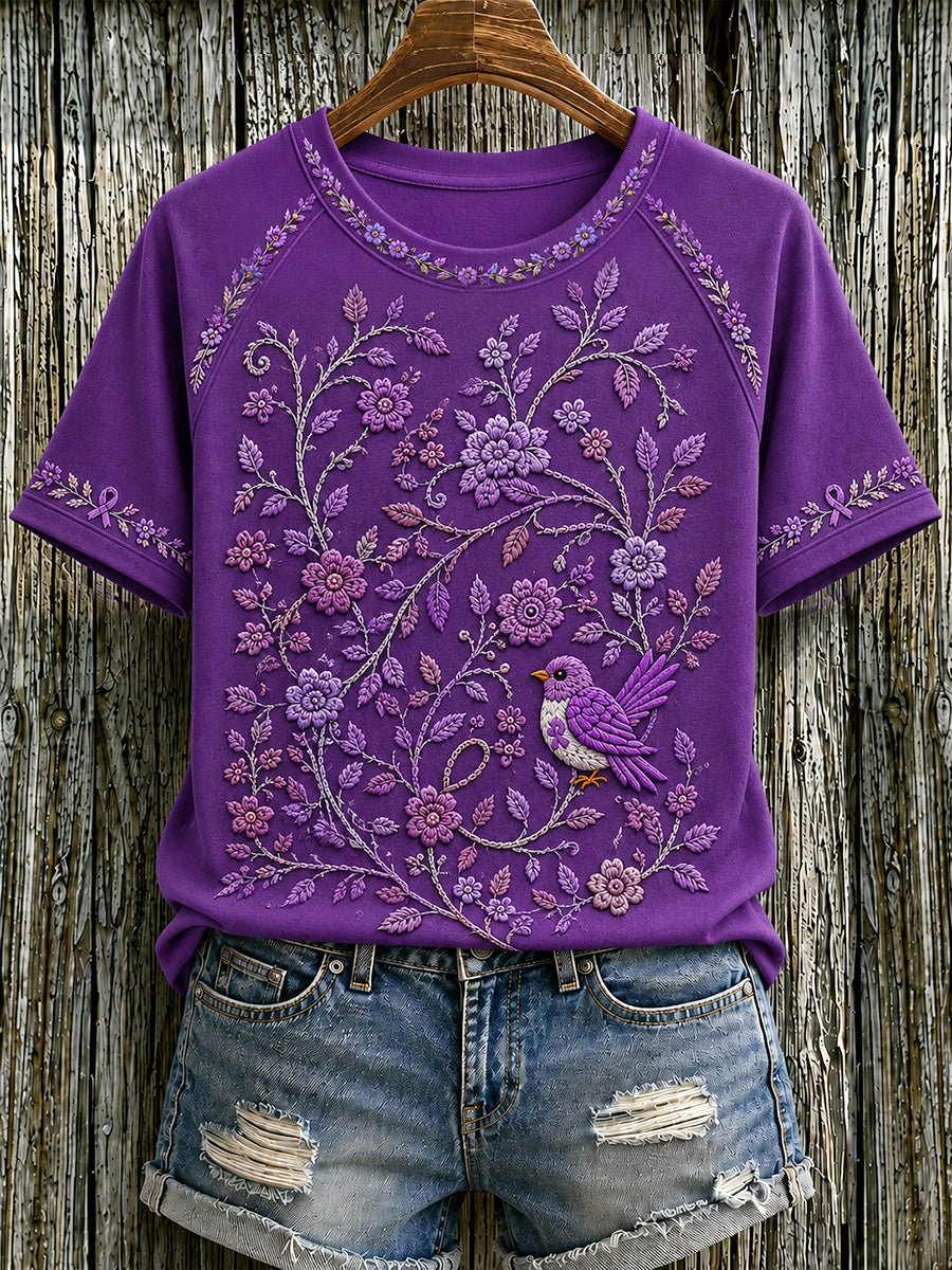Damen-T-Shirt in Lila mit Blumen- und Kolibri-Print zur Sensibilisierung für die Alzheimer-Krankheit