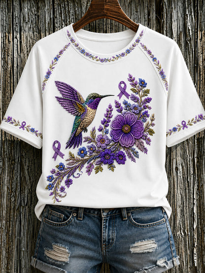 Damen-T-Shirt in Lila mit Blumen- und Kolibri-Print zur Sensibilisierung für die Alzheimer-Krankheit