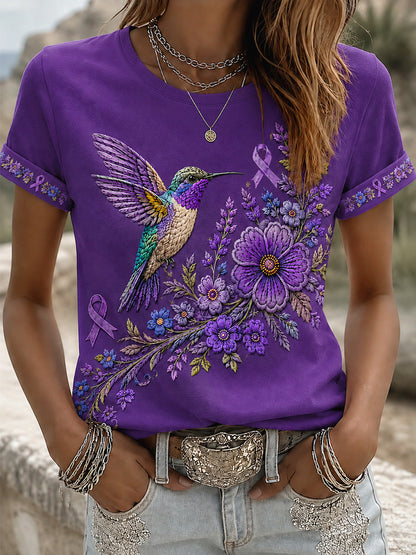 Damen-T-Shirt in Lila mit Blumen- und Kolibri-Print zur Sensibilisierung für die Alzheimer-Krankheit