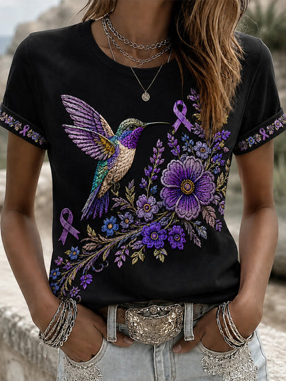 Damen-T-Shirt in Lila mit Blumen- und Kolibri-Print zur Sensibilisierung für die Alzheimer-Krankheit